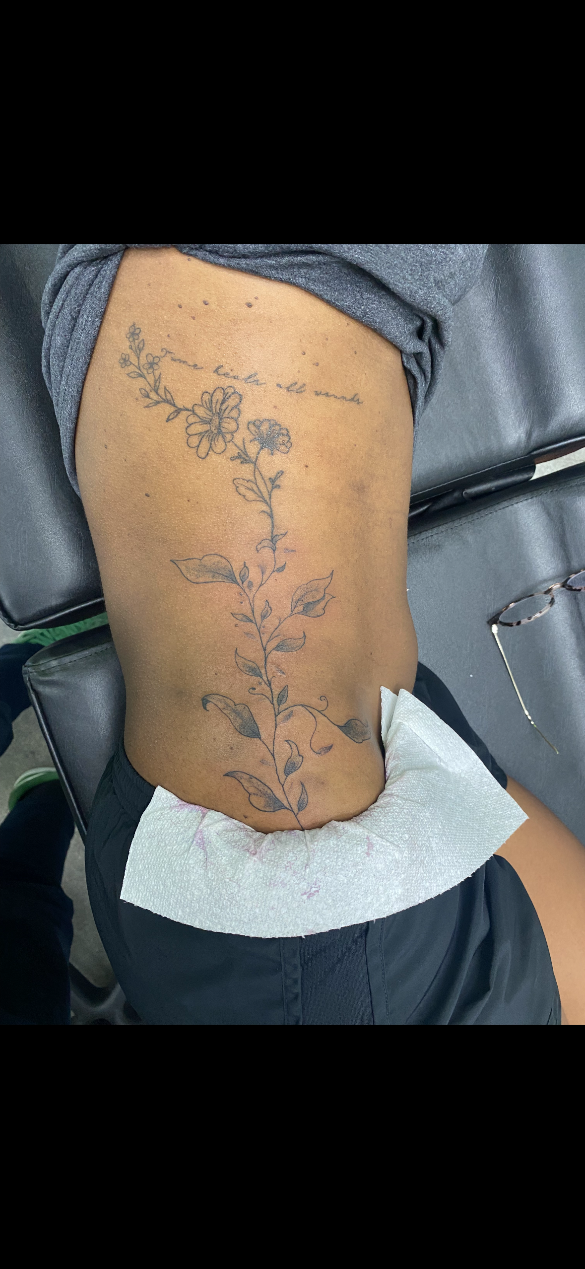 Person with a floral tattoo on their side
